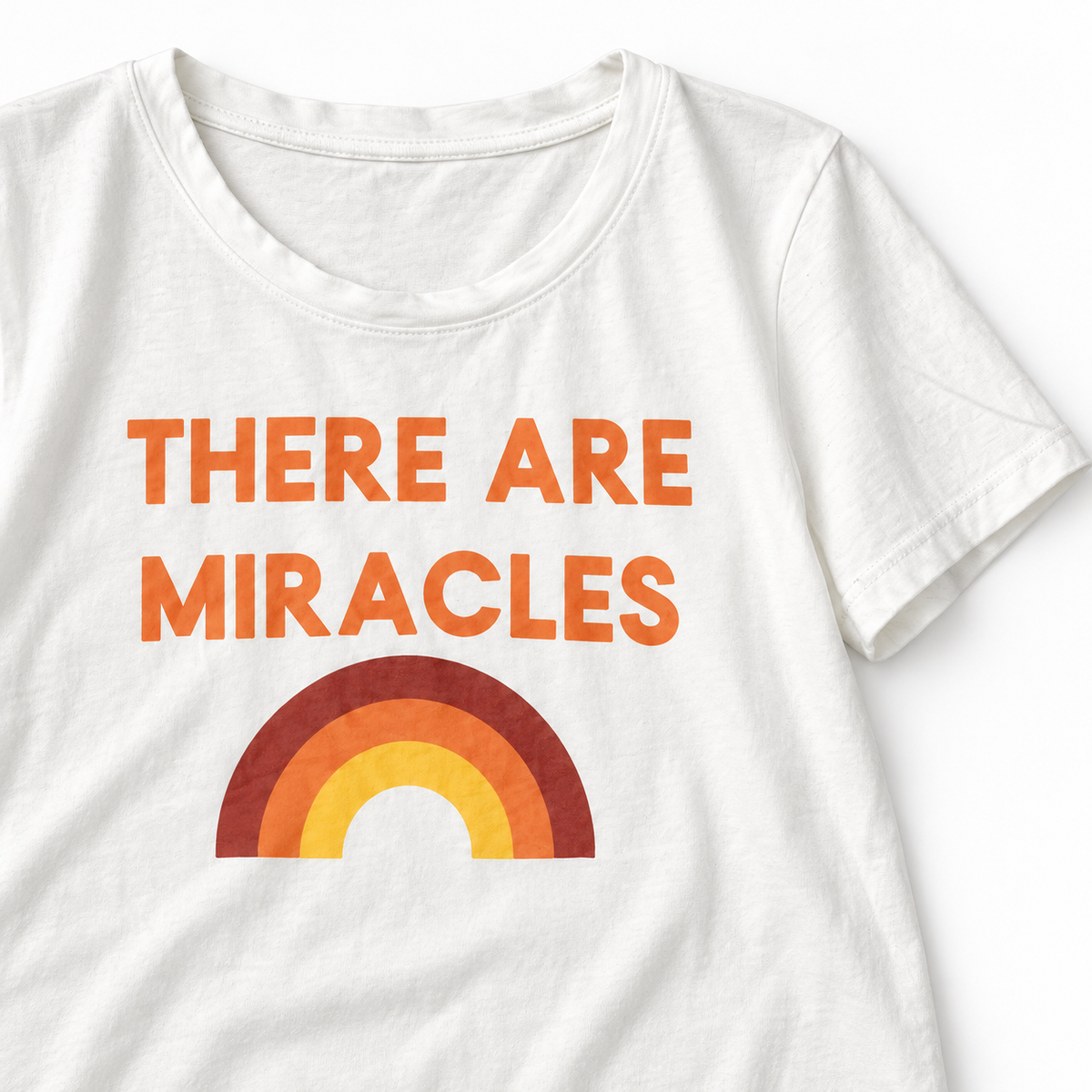 There Are Miracles women's tee, close view of the neckline, sewn sleeve hem and rainbow graphic