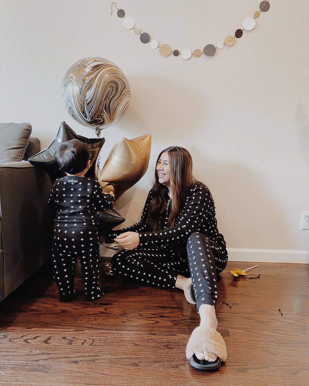 Organic Baby + Kids Pajama Set | White on Black Swiss Cross — Family lifestyle view beside balloons