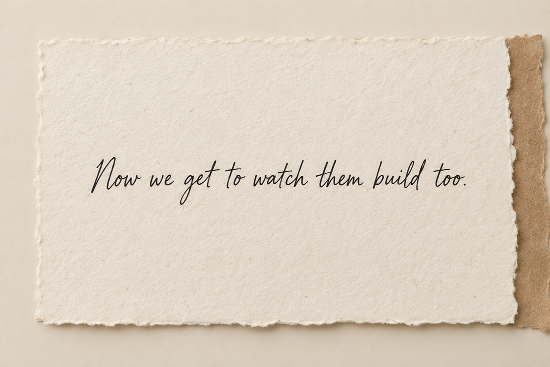 Handwritten artwork on ivory handmade paper reading Now we get to watch them build too.