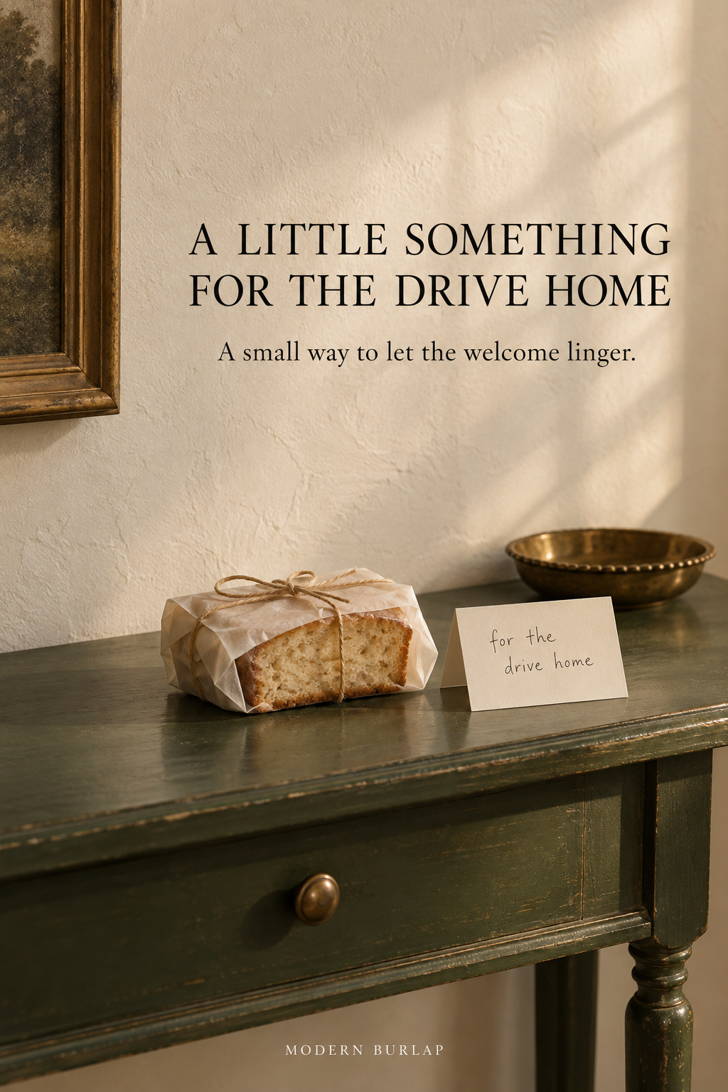A parchment-wrapped loaf and handwritten card reading for the drive home on a deep green console.