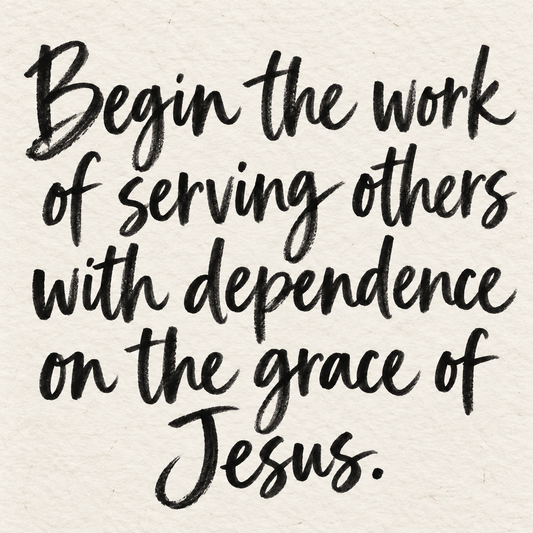 Black brush lettering on ivory handmade paper: “Begin the work of serving others with dependence on the grace of Jesus.”
