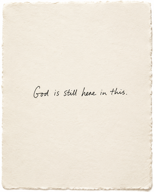 Handwritten artwork on ivory handmade paper: God is still here in this.