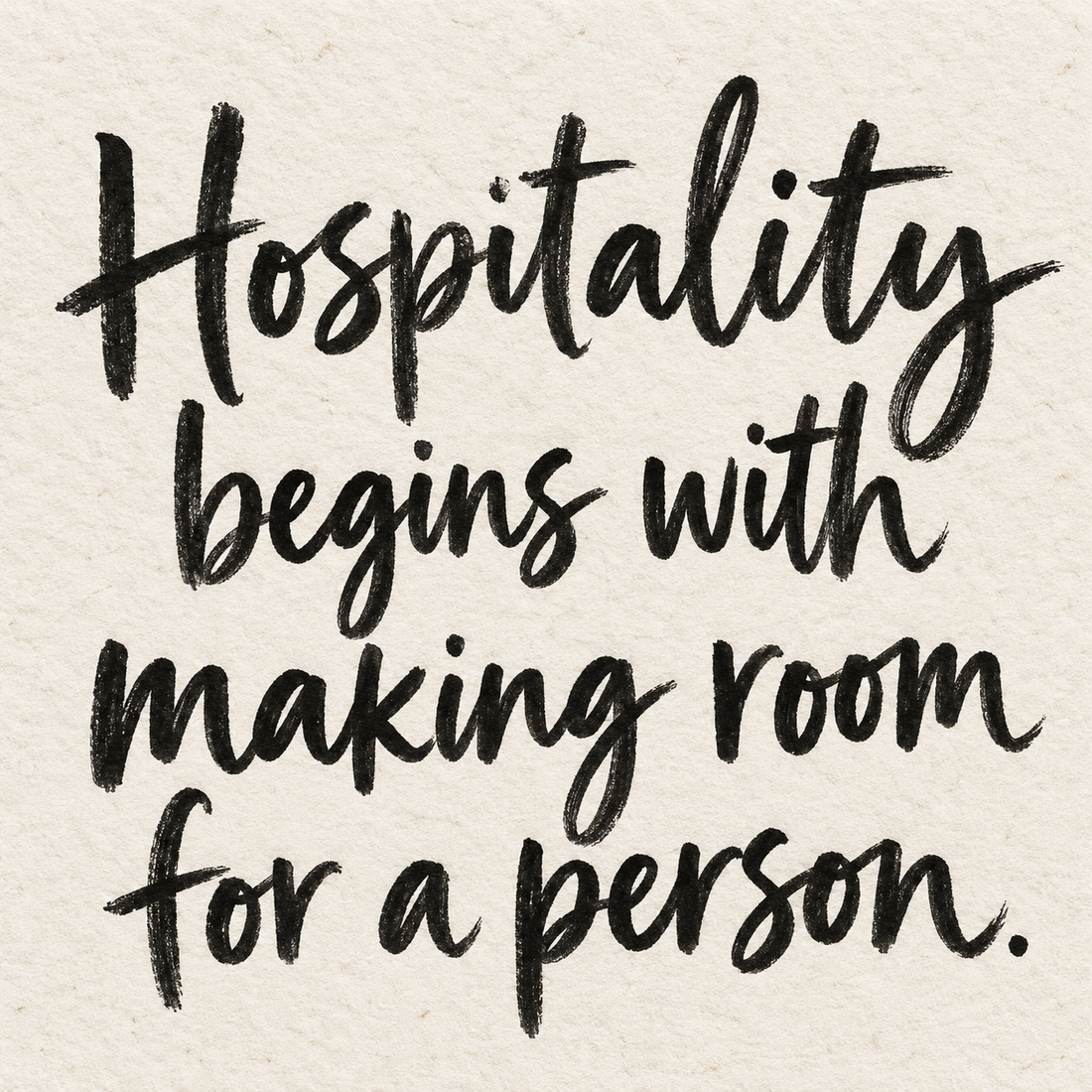 Black brush lettering on ivory handmade paper: “Hospitality begins with making room for a person.”