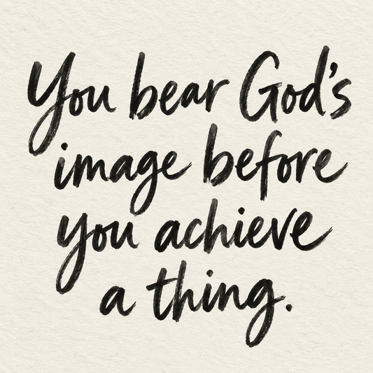 Black brush lettering on ivory handmade paper: “You bear God's image before you achieve a thing.”