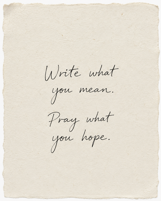 Write what you mean. Pray what you hope, handwritten in black ink on ivory handmade paper