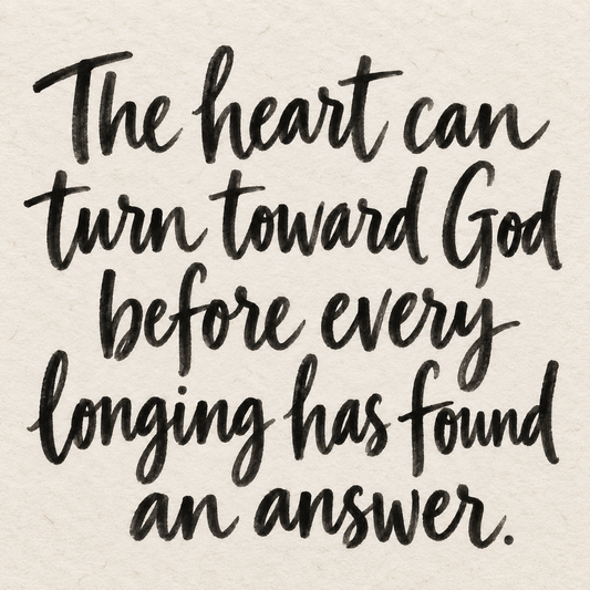 Black brush lettering on ivory handmade paper: “The heart can turn toward God before every longing has found an answer.”