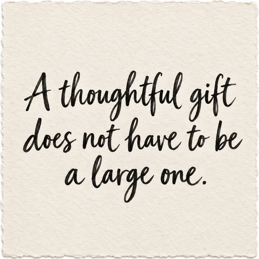 Handwritten artwork on ivory handmade paper reading A thoughtful gift does not have to be a large one.