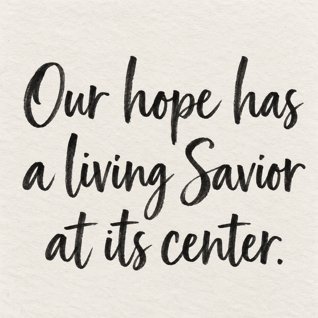 Black brush lettering on ivory handmade paper: “Our hope has a living Savior at its center.”