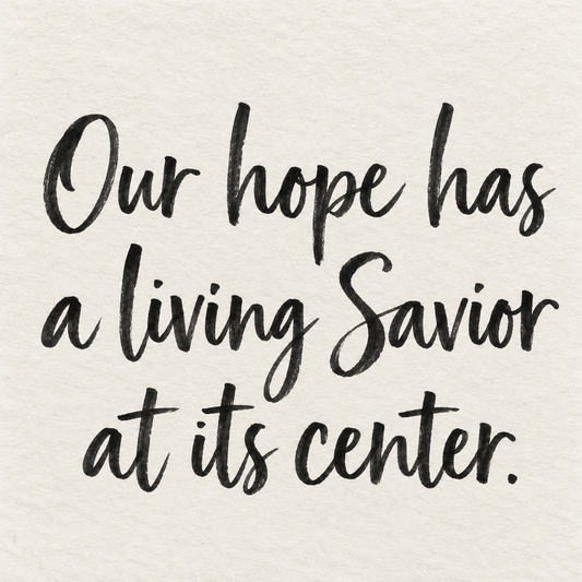 Black brush lettering on ivory handmade paper: “Our hope has a living Savior at its center.”