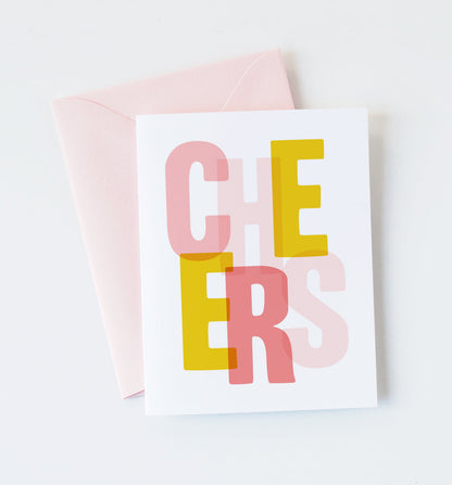 Cheers greeting card by Graphic Anthology, with pink and yellow lettering and blush envelope.