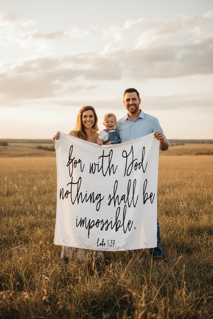 Family holding up Luke 1:37 Scripture Swaddle.