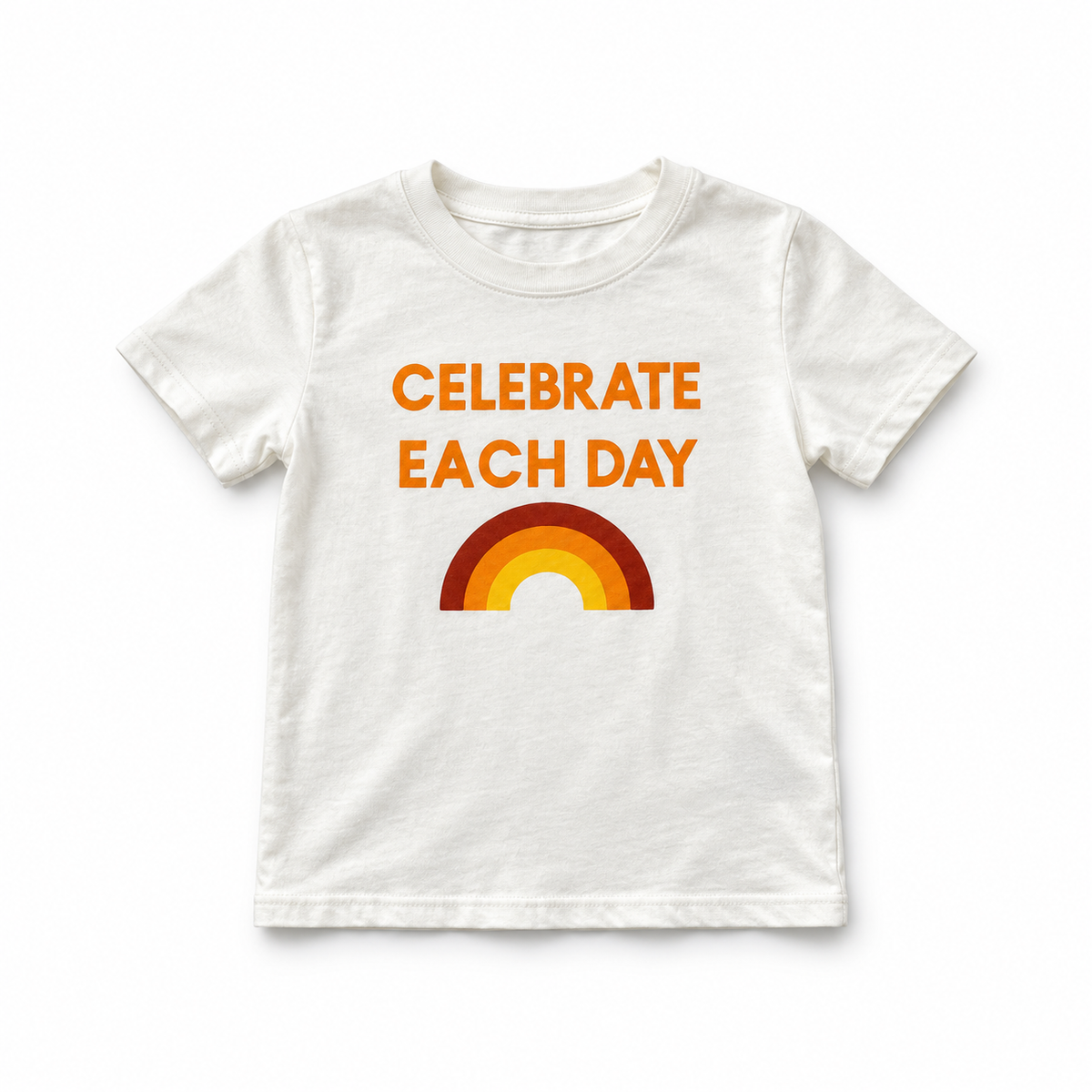 Celebrate Each Day kids tee in ivory, front studio view with orange lettering and three-color rainbow