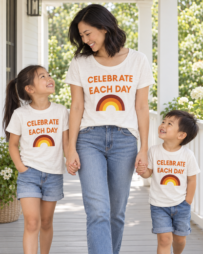 AI-styled mother and two children wearing coordinating Celebrate Each Day tees; each tee sold separately