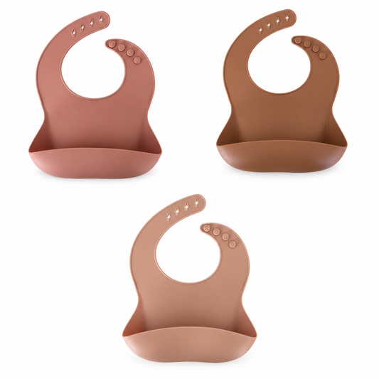Little Eli silicone bibs in Cherry Blossom, Copper Clay and Light Coral, sold separately.