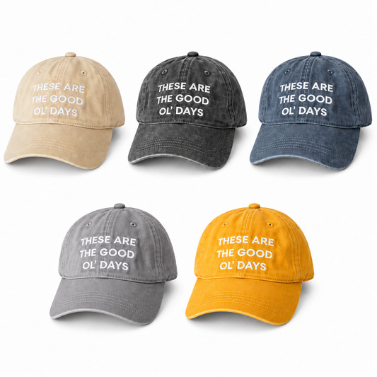 Five child-size These Are the Good Ol’ Days caps in Beige, Washed Black, Washed Blue, Gray and Yellow, arranged at matching scale on white.