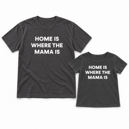 Home Is Where the Mama Is adult and kids' tees together in a studio flat lay; each tee sold separately.