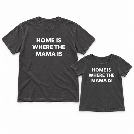 Home Is Where the Mama Is adult and kids' tees together in a studio flat lay; each tee sold separately.