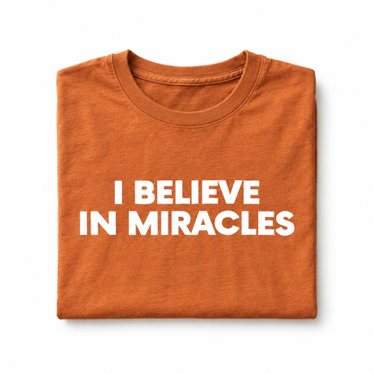 I Believe in Miracles Sunburn tee, folded studio detail with white lettering