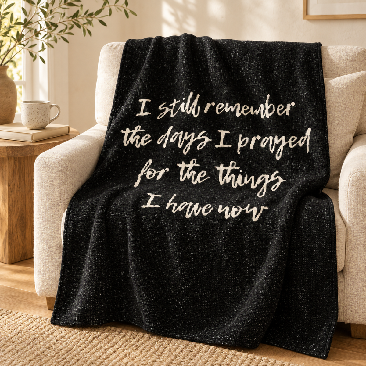 I Still Remember the Days I Prayed recycled cotton blanket — Black throw draped over an ivory armchair