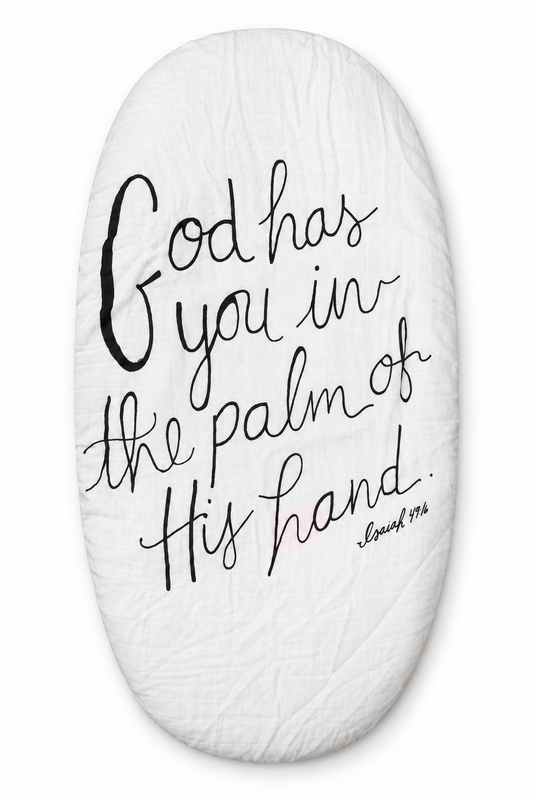 Isaiah 49:16 organic muslin bassinet and small changing pad sheet, fitted product view. Sheet sold separately; pad not included.