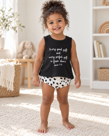 AI-styled toddler wearing the black James 1:17 tank with spotted bloomers; bottoms sold separately.