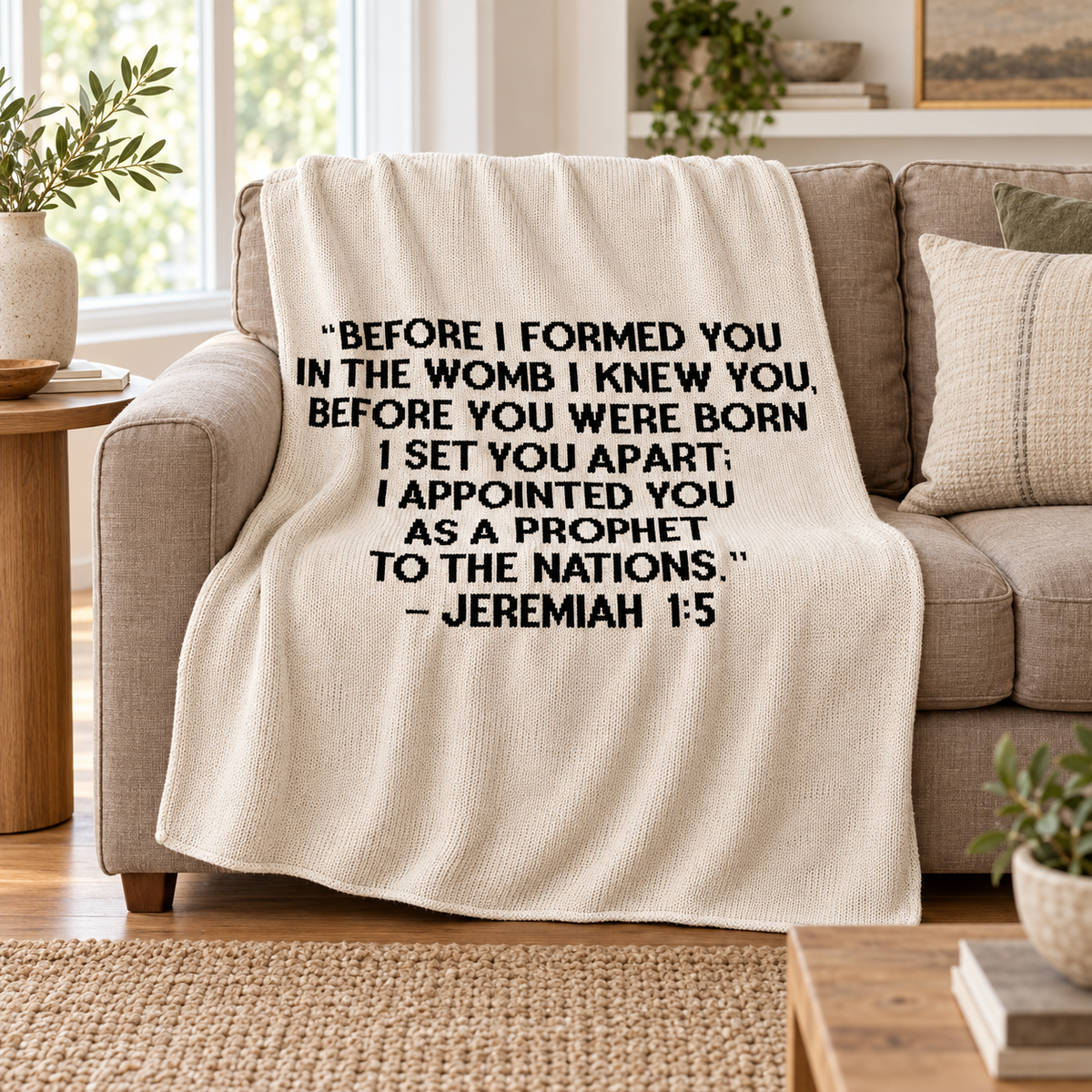 Jeremiah 1:5 Block Lettering blanket in Natural — throw draped on a taupe sofa