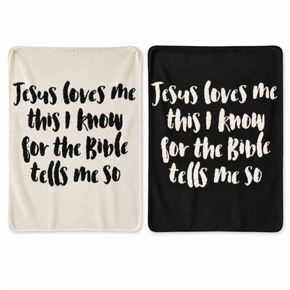 Jesus Loves Me Classic knit throw in Natural and Black, shown side by side. Each color sold separately.