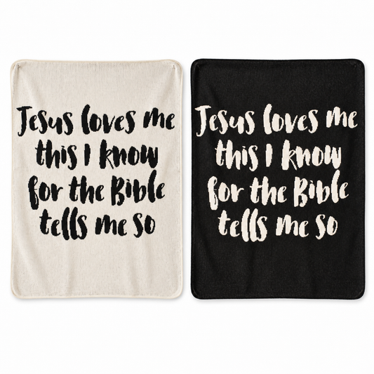Jesus Loves Me Classic knit throw in Natural and Black, shown side by side. Each color sold separately.