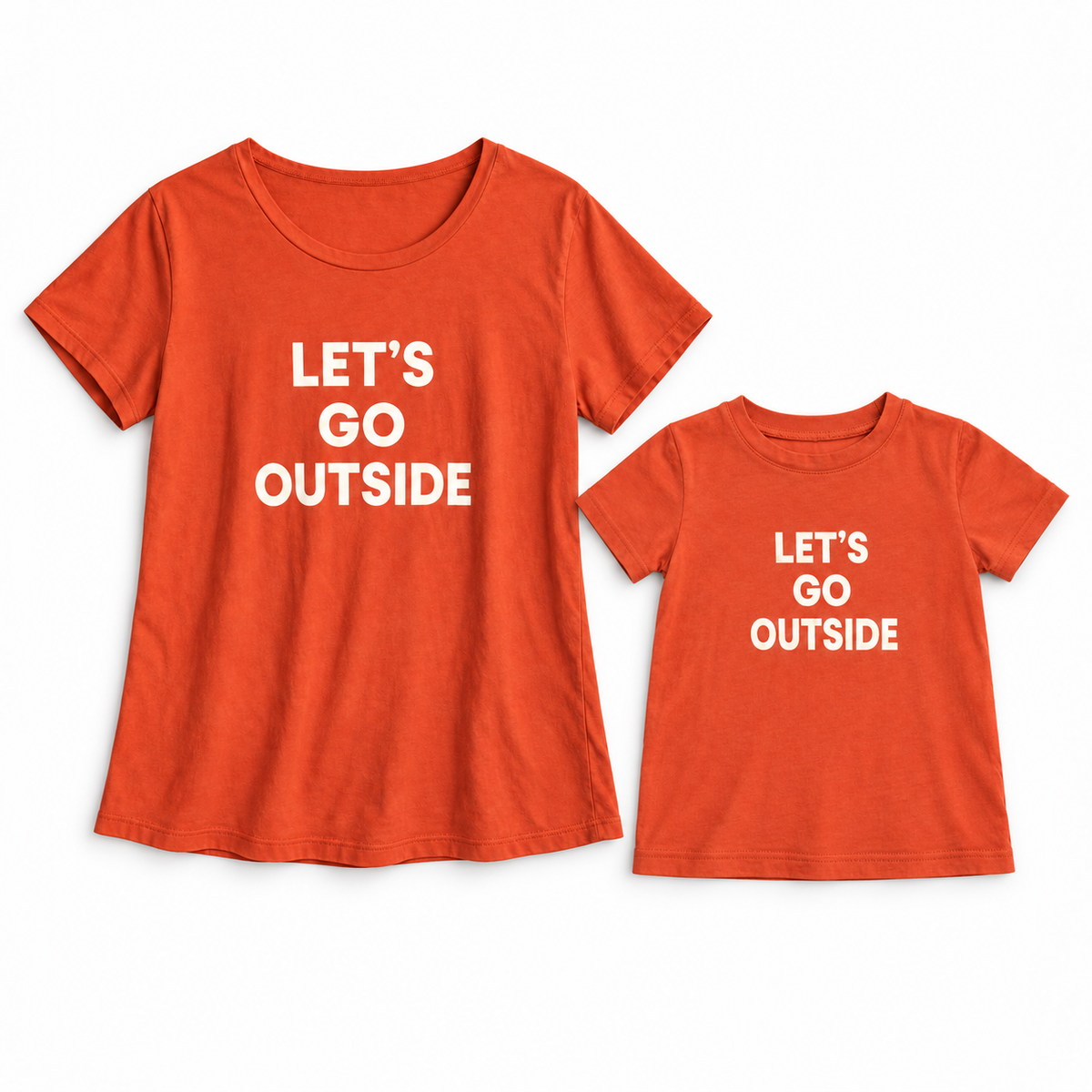 Let’s Go Outside adult and kids' tees together in a studio flat lay; each tee sold separately.