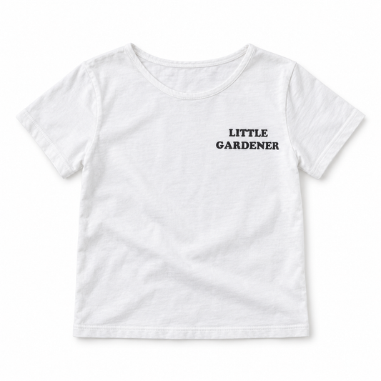 White Little Gardener kids tee, front studio view with narrow scoop neckline and black left-chest lettering