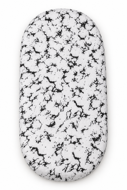 Marble organic bassinet and small changing pad sheet shown fitted on a pad against white.
