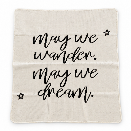 Natural May We Wander May We Dream blanket with script lettering and stars, shown fully extended on a white background.