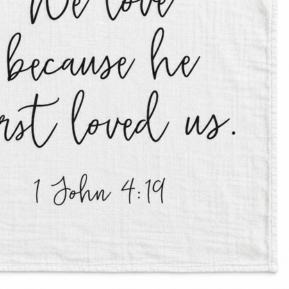 1 John 4:19 Scripture swaddle detail showing the printed lettering and hem.