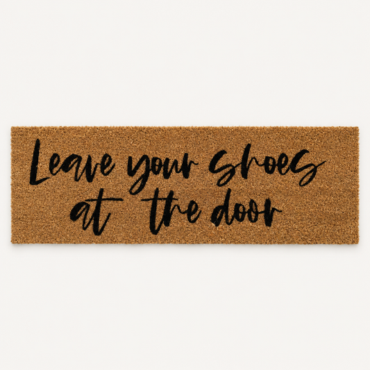 Leave Your Shoes at the Door | XL Doormat shown alone on a warm off-white studio background.