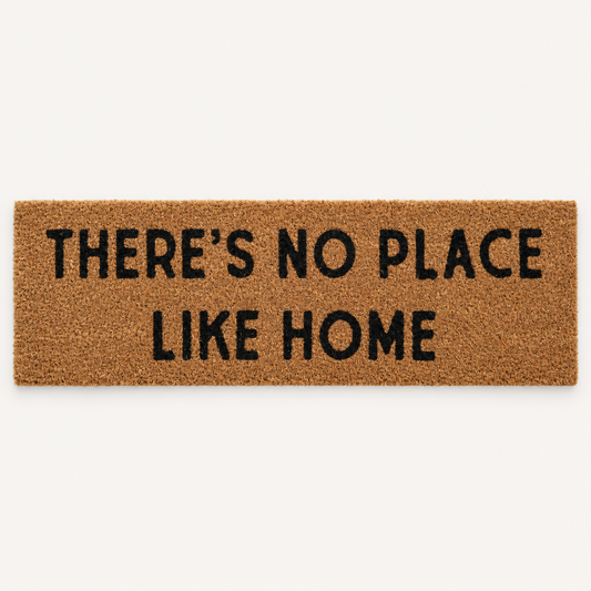 There's No Place Like Home | XL Doormat shown alone on a warm off-white studio background.
