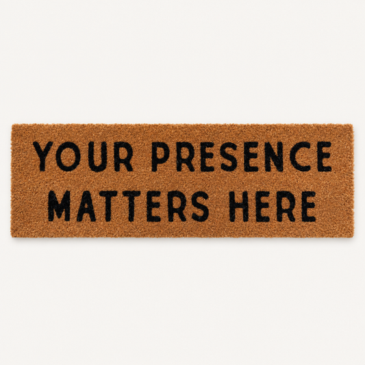 Your Presence Matters Here | XL Doormat shown alone on a warm off-white studio background.