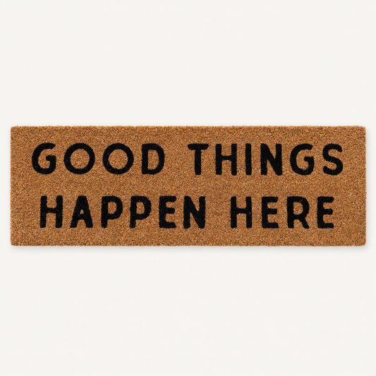Good Things Happen Here | XL Doormat shown alone on a warm off-white studio background.