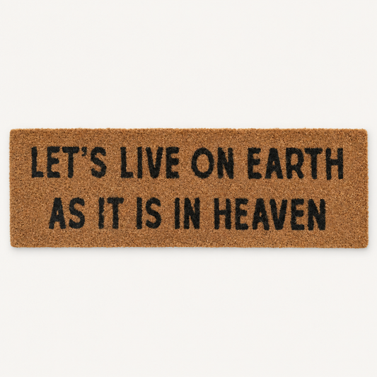 Let's Live on Earth as It Is in Heaven | XL Doormat shown alone on a warm off-white studio background.