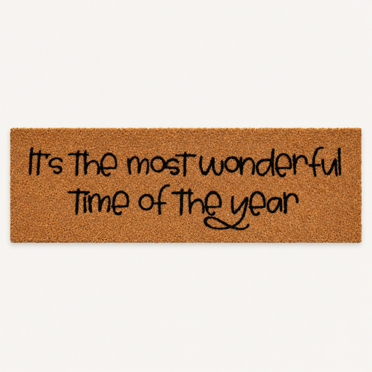 It's the Most Wonderful Time of the Year | XL Doormat shown alone on a warm off-white studio background.