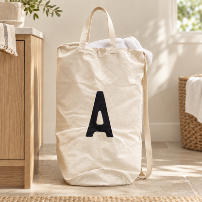 A initial cotton canvas bag in a bright laundry room