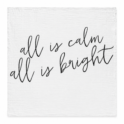 All Is Calm All Is Bright organic muslin swaddle laid fully open on white, showing the original black handwritten lettering and square stitched edges.