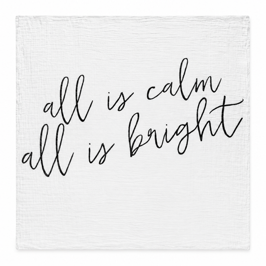 All Is Calm All Is Bright organic muslin swaddle laid fully open on white, showing the original black handwritten lettering and square stitched edges.