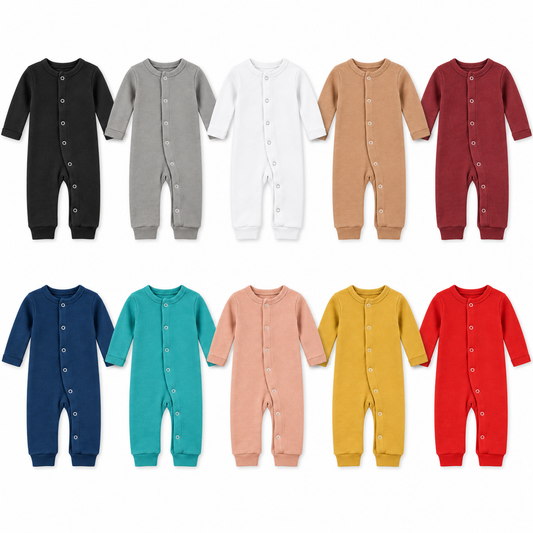 All 10 solid colors of Modern Burlap organic baby button coveralls, flat lay on white.