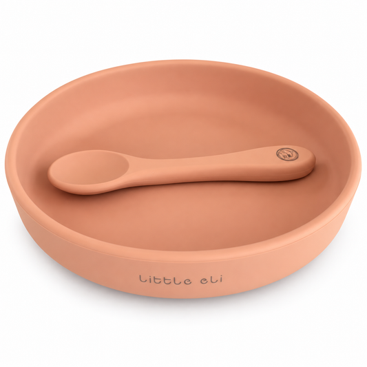 Little Eli Cherry Blossom mini round silicone plate with matching spoon on white; storage bag included but not shown.