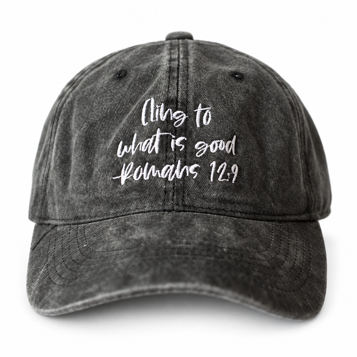 Washed black adult cap embroidered Cling to what is good, Romans 12:9.