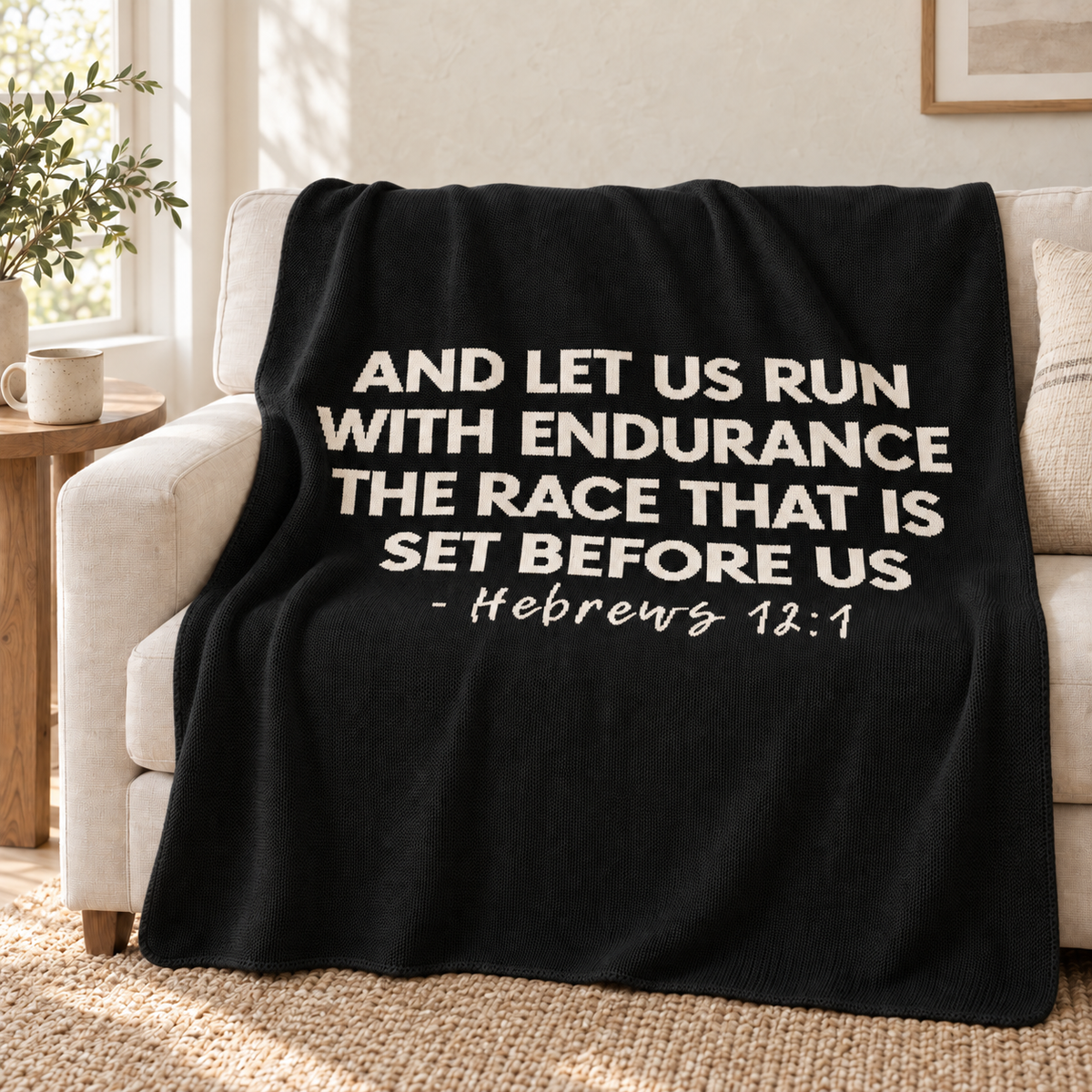 Black Hebrews 12:1 knit throw draped over an ivory sofa.