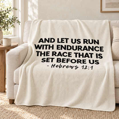 Natural Hebrews 12:1 knit throw draped over an ivory sofa.