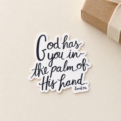 AI-styled gift view of the Isaiah 49:16 sticker beside a kraft gift box; one sticker included, box and ribbon are props.