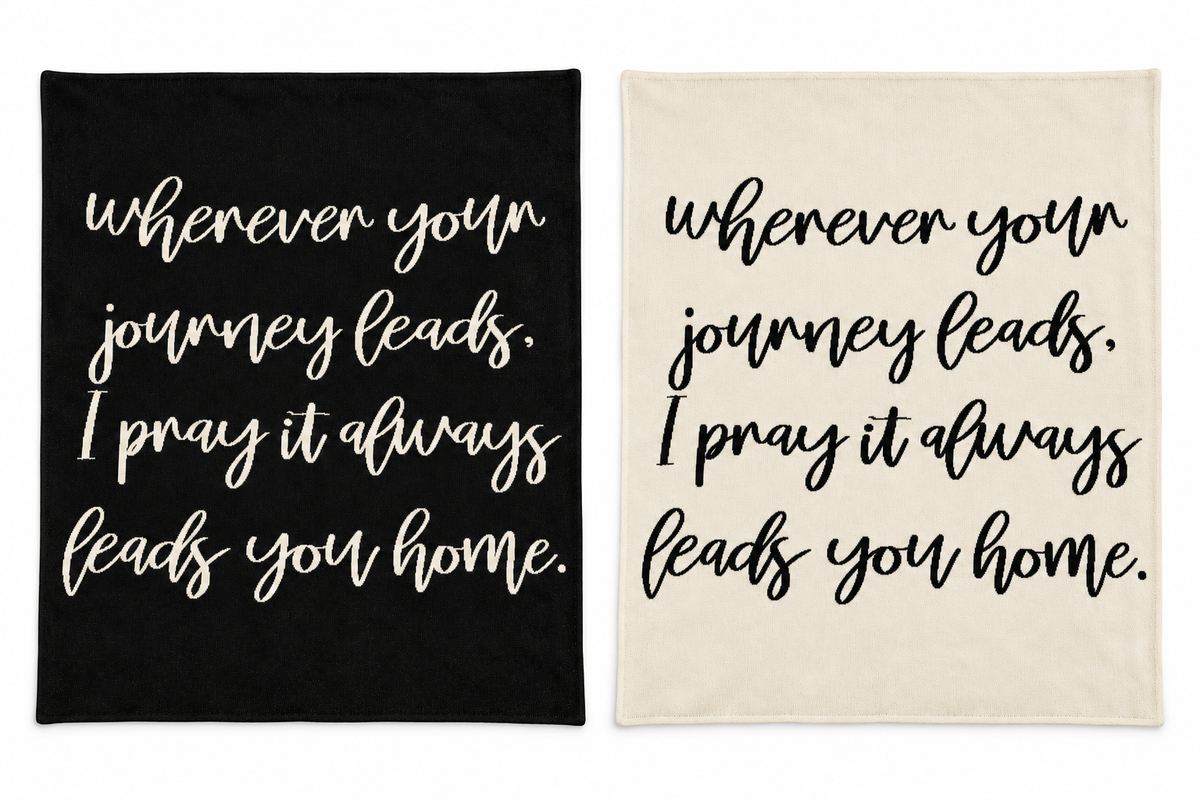 Wherever Your Journey knit blankets in Black and Natural, shown together on white.