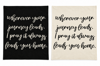 Wherever Your Journey knit blankets in Black and Natural, shown together on white.